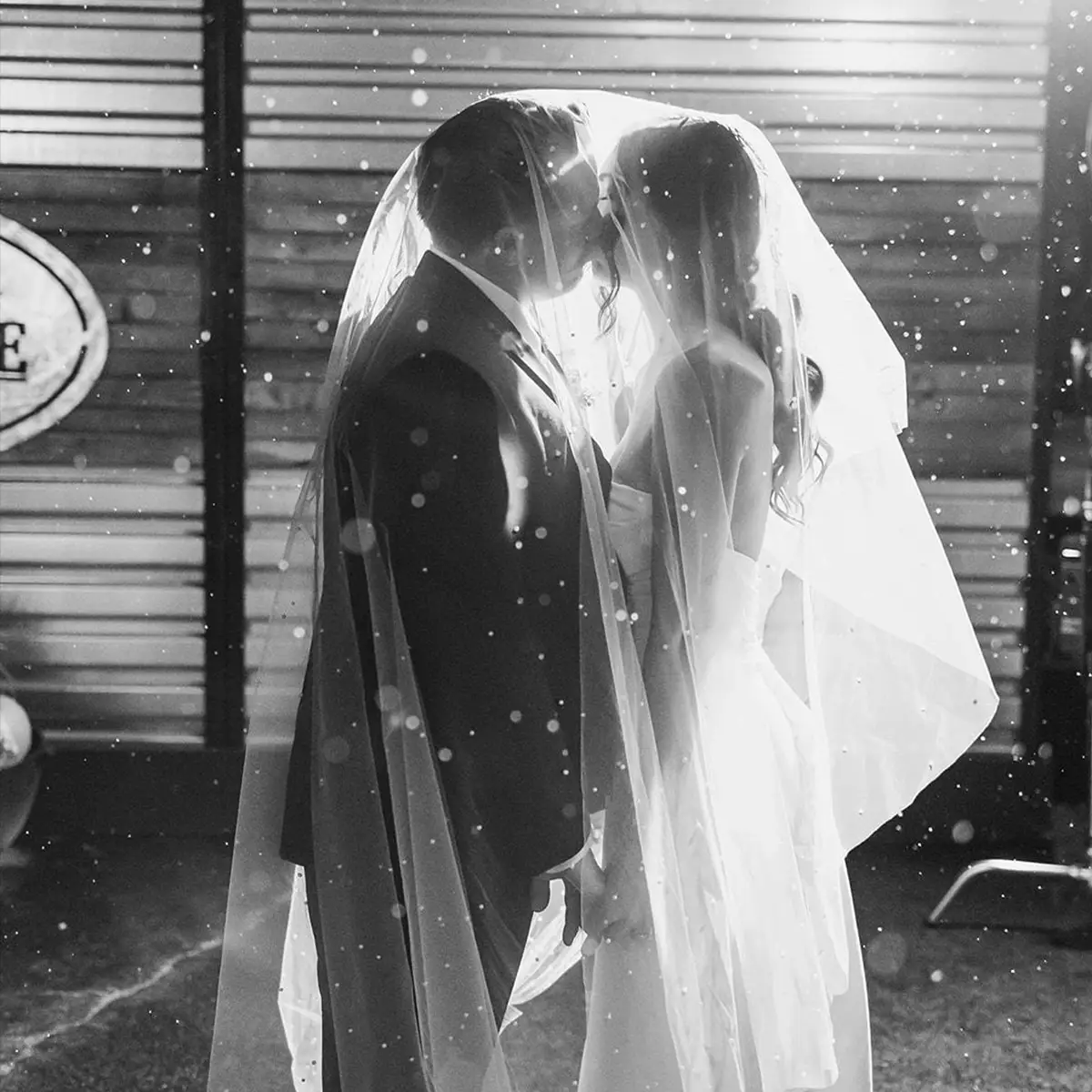 Bride and Groom Kissing in the Rain