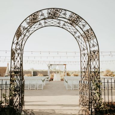 metal arch at outdoor wedding ceremony entrance